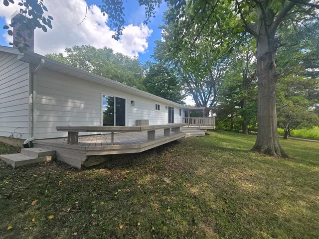 a view of a house with backyard and sitting area