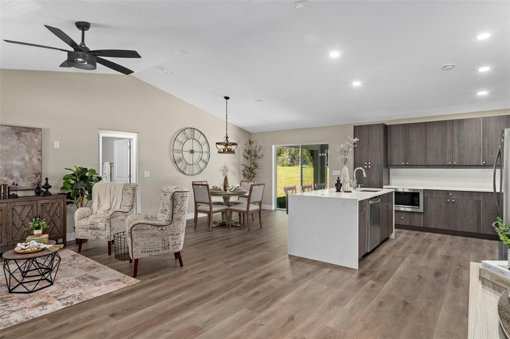 3011 East Griffin Street Inverness, FL 34453 - Photo 12 of 45 a living room with furniture a clock on wall and a window