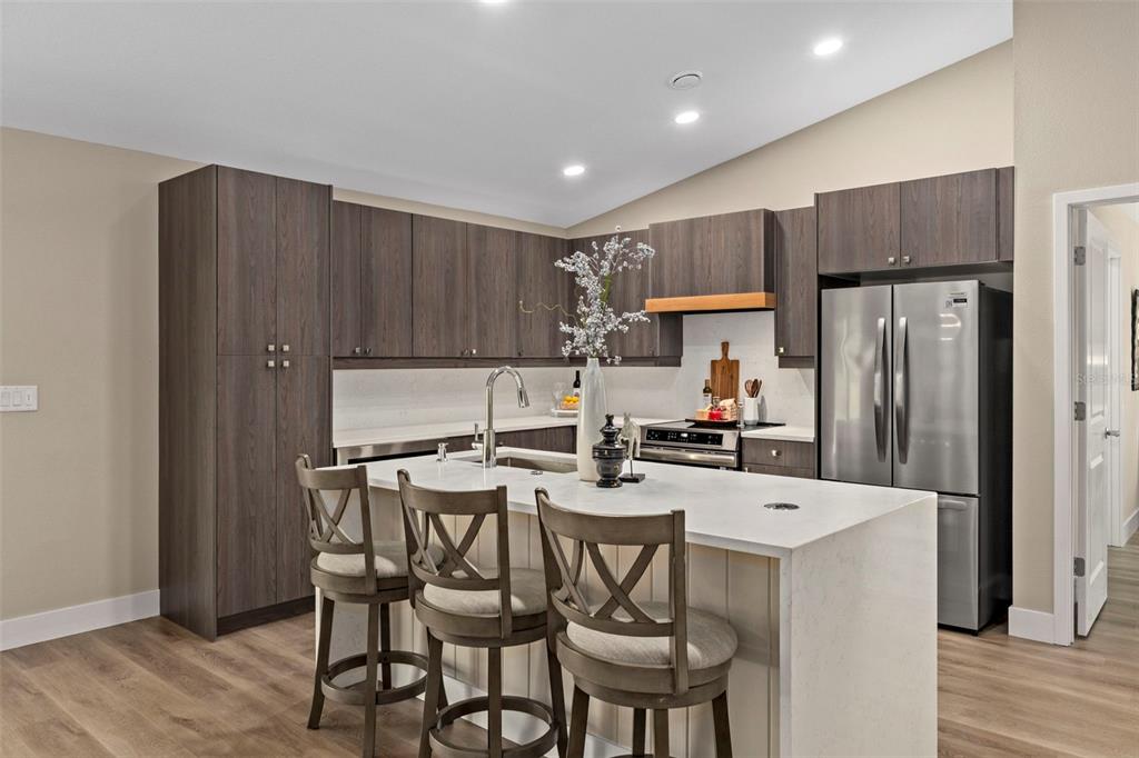 3011 East Griffin Street Inverness, FL 34453 - Photo 19 of 45 a kitchen with a dining table chairs refrigerator and cabinets
