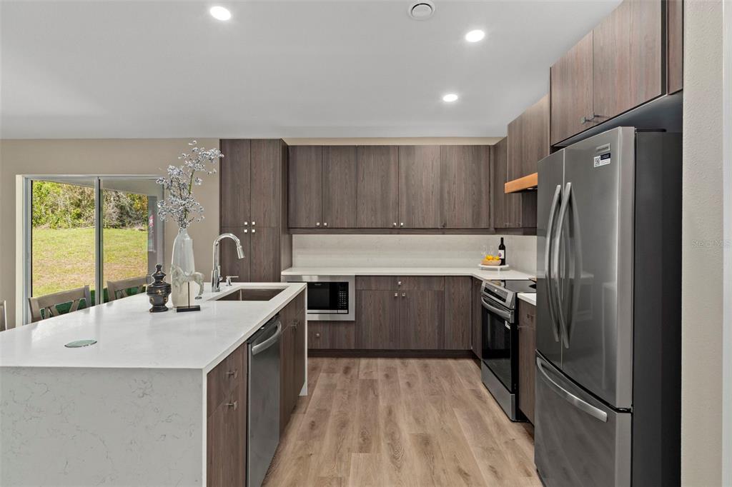 3011 East Griffin Street Inverness, FL 34453 - Photo 20 of 45 a kitchen with a sink stove and refrigerator