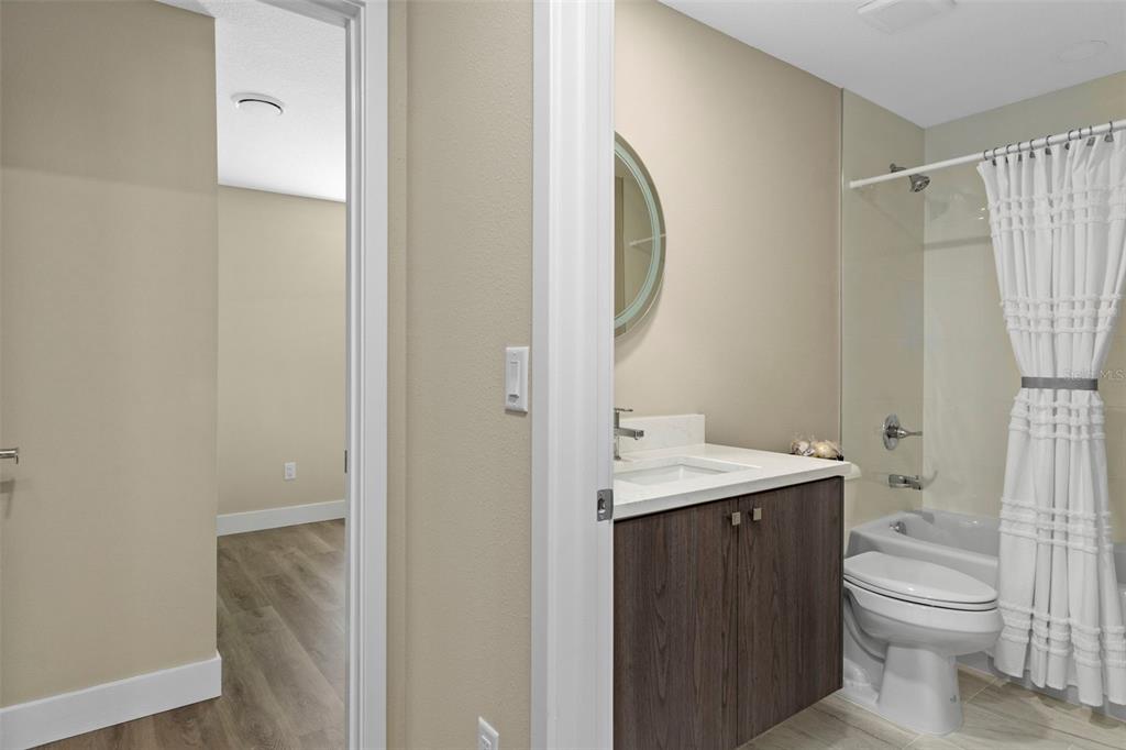 3011 East Griffin Street Inverness, FL 34453 - Photo 32 of 45 a bathroom with a granite countertop sink toilet and shower