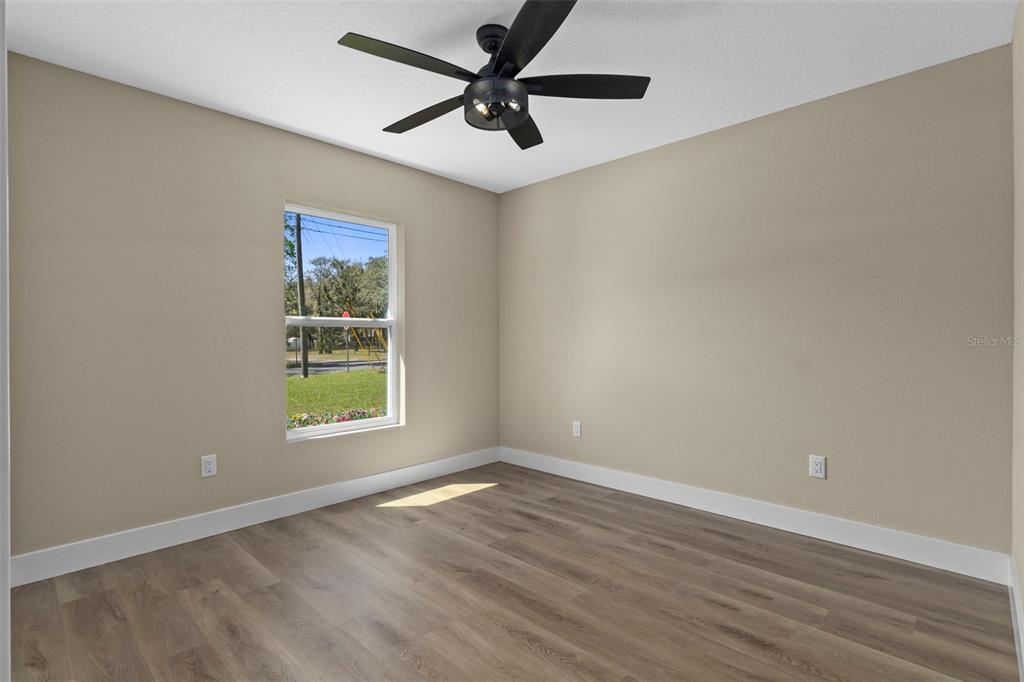 3011 East Griffin Street Inverness, FL 34453 - Photo 34 of 45 an empty room with wooden floor and windows