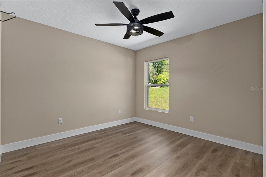 3011 East Griffin Street Inverness, FL 34453 - Photo 36 of 45 an empty room with a window and a fan
