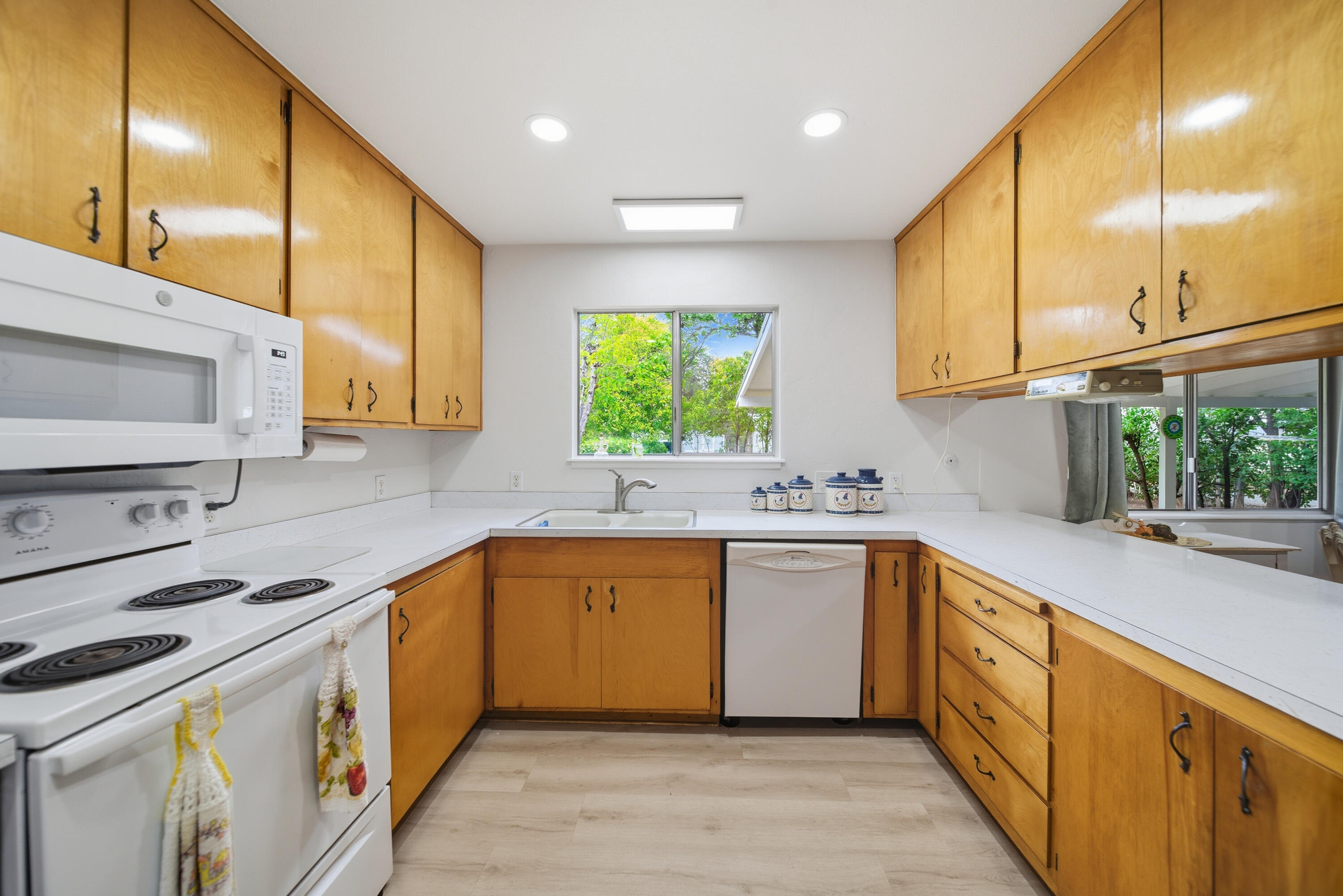 9807 Logan Road Palo Cedro, CA 96073 - Photo 14 of 53 a kitchen with a sink window and cabinets