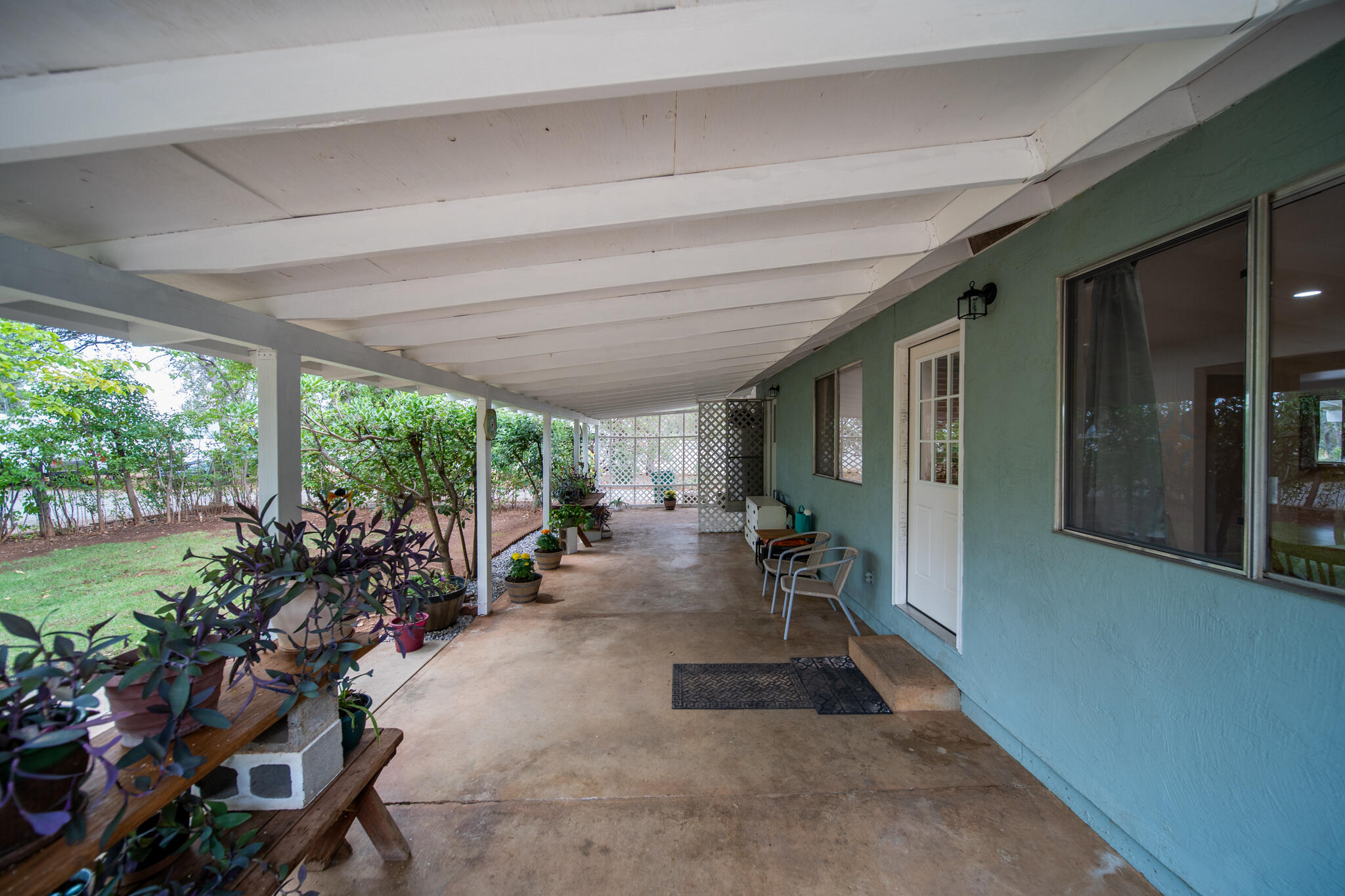 9807 Logan Road Palo Cedro, CA 96073 - Photo 34 of 53 a view of a patio with table and chairs potted plants with floor to ceiling window