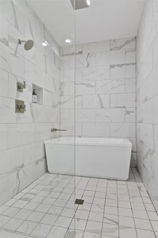 a bathroom with a bathtub and shower