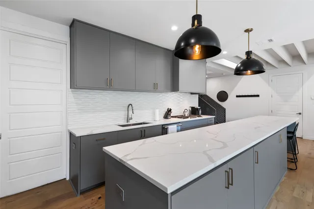 a kitchen with a sink and cabinets