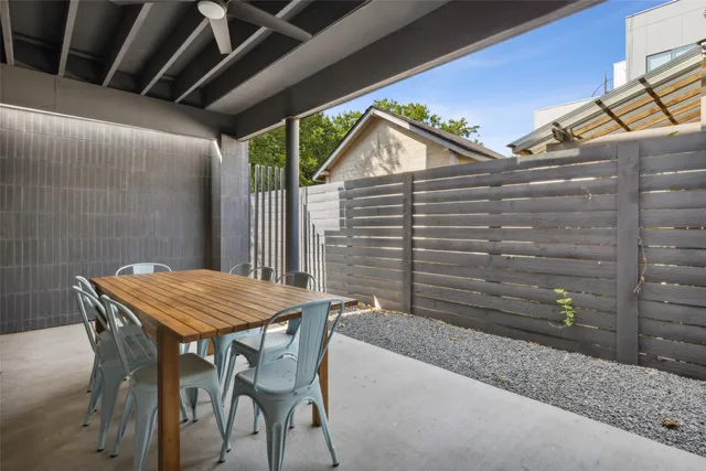 a backyard of a house with table and chairs