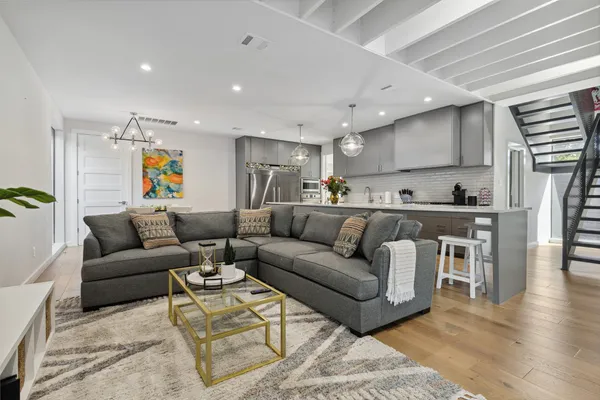a living room with furniture and kitchen view