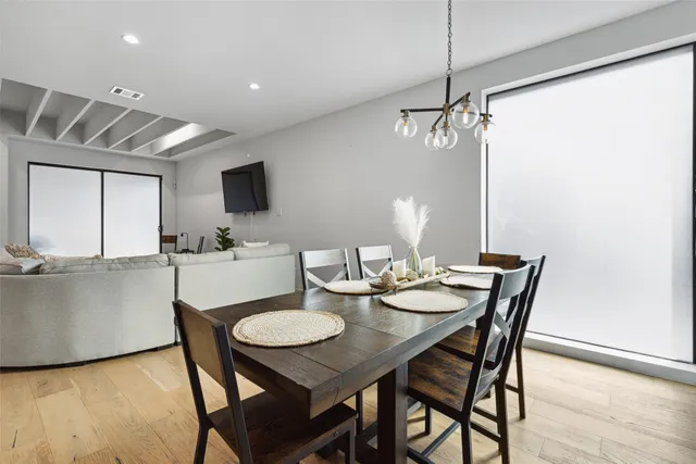 a view of a dining room with furniture window and wooden floor