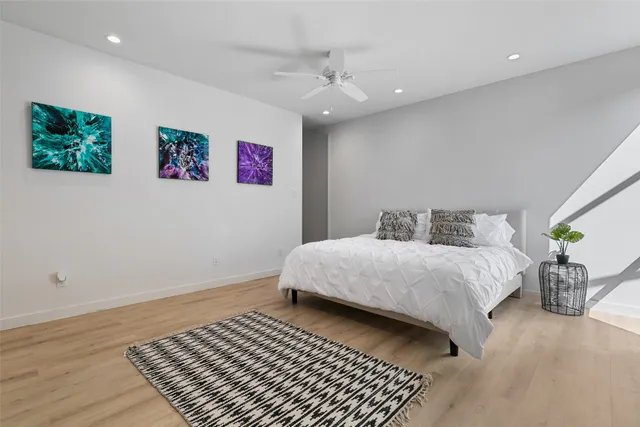 a bedroom with a large bed and a chandelier