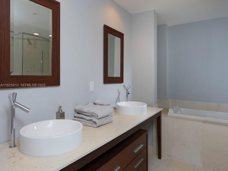 495 Brickell Avenue, Unit 4205 Miami, FL 33131 - Photo 12 of 21 a bathroom with a sink and a mirror
