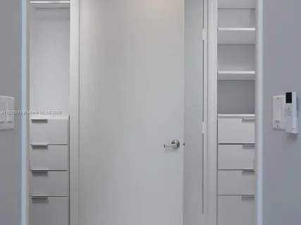 a bedroom with a bed and a night stand