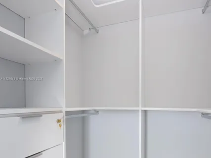 a large bed sitting in a bedroom next to a window