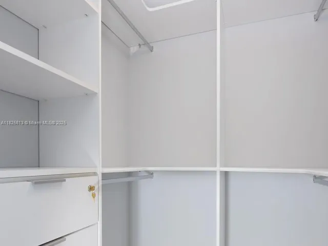 a large bed sitting in a bedroom next to a window