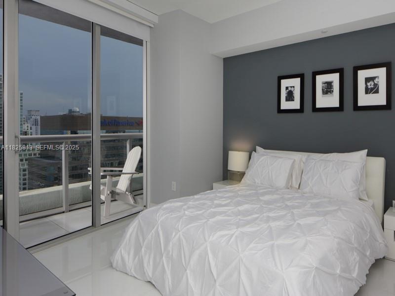 495 Brickell Avenue, Unit 4205 Miami, FL 33131 - Photo 17 of 21 a large bed sitting in a bedroom next to a window