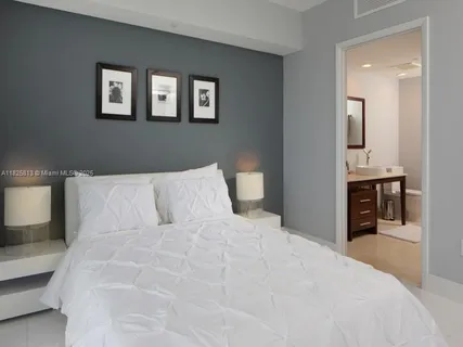 a bathroom with a sink mirror and toilet