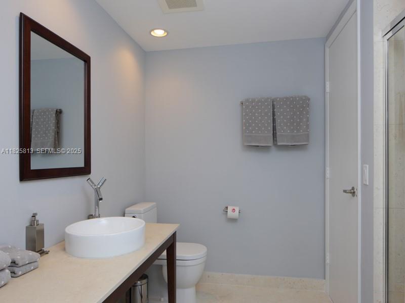 495 Brickell Avenue, Unit 4205 Miami, FL 33131 - Photo 20 of 21 a bathroom with a sink mirror and toilet