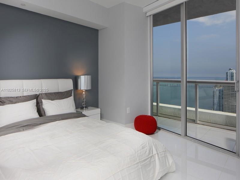 495 Brickell Avenue, Unit 4205 Miami, FL 33131 - Photo 9 of 21 a bedroom with a bed and walk in closet