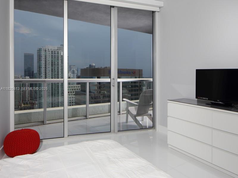 495 Brickell Avenue, Unit 4205 Miami, FL 33131 - Photo 10 of 21 a bedroom with a bed and a flat screen tv