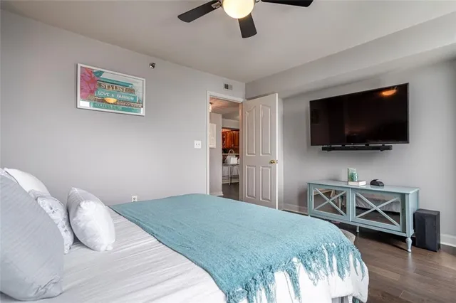 a bedroom with a bed and a flat screen tv