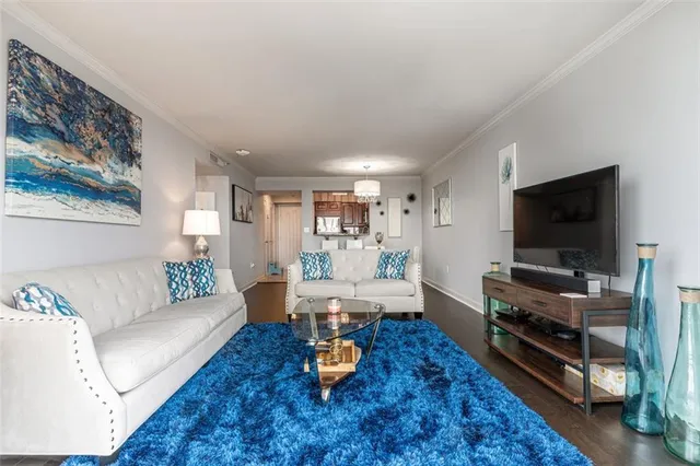 a living room with furniture and a flat screen tv