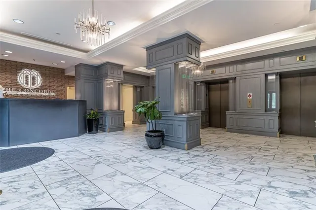 a lobby with furniture and a chandelier