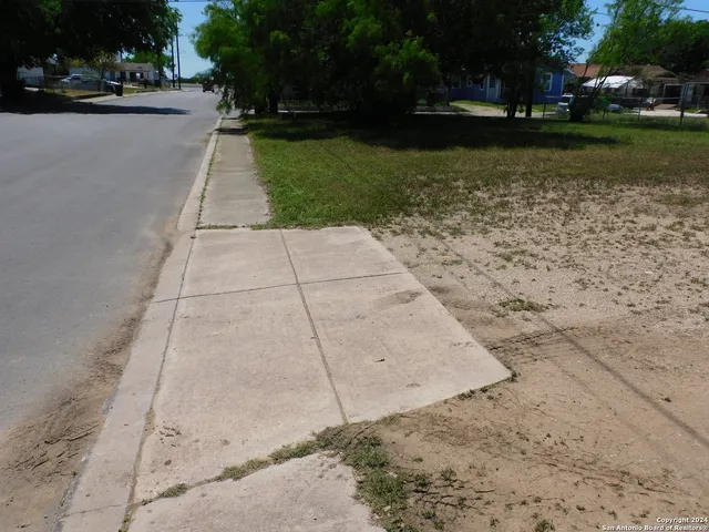 a view of a street with a large trees
