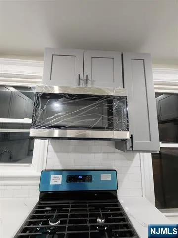 a stove top oven sitting inside of a kitchen