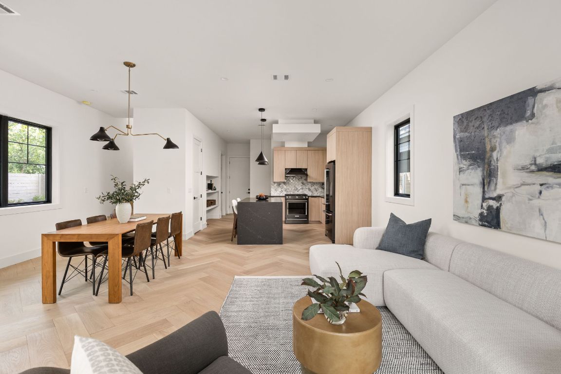 2707 Stacy Lane, Unit 1 Austin, TX 78704 - Photo 12 of 40 a living room with furniture kitchen view and a chandelier