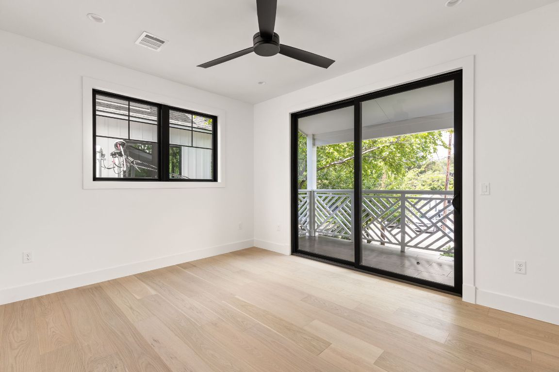 2707 Stacy Lane, Unit 1 Austin, TX 78704 - Photo 21 of 40 a view of an empty room with wooden floor and a window