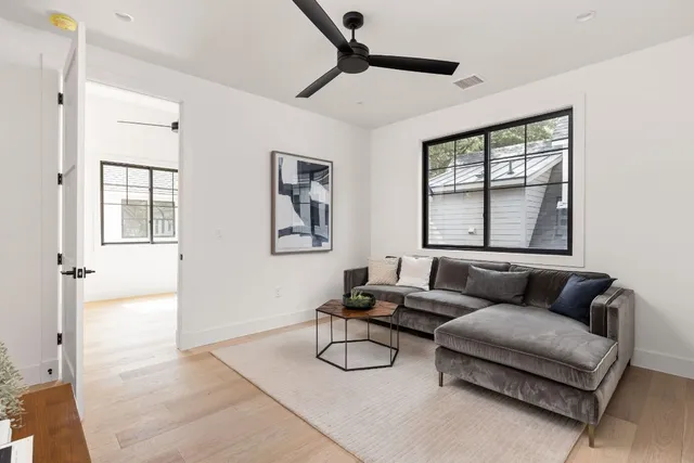 a bathroom with a granite countertop sink toilet and mirror