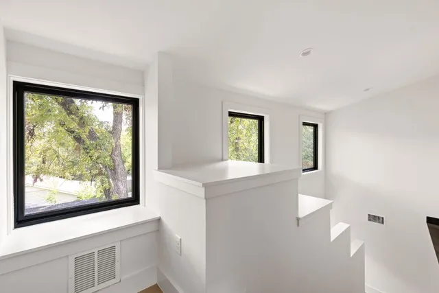 a view of a bedroom with wooden floor and furniture