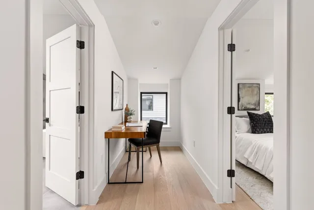 a spacious bedroom with a bed and a chandelier