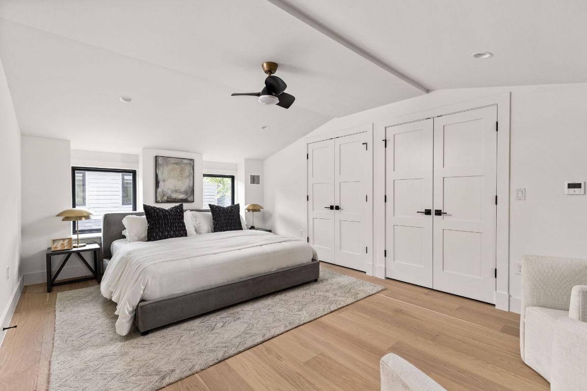 2707 Stacy Lane, Unit 1 Austin, TX 78704 - Photo 31 of 40 a spacious bedroom with a bed and a chandelier