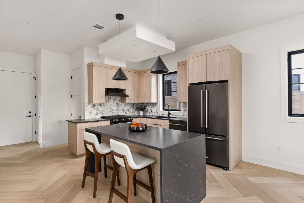 2707 Stacy Lane, Unit 1 Austin, TX 78704 - Photo 8 of 40 a kitchen with refrigerator a sink and chairs