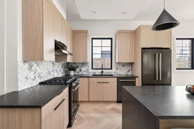 a dining room with stainless steel appliances kitchen island granite countertop furniture and a kitchen view