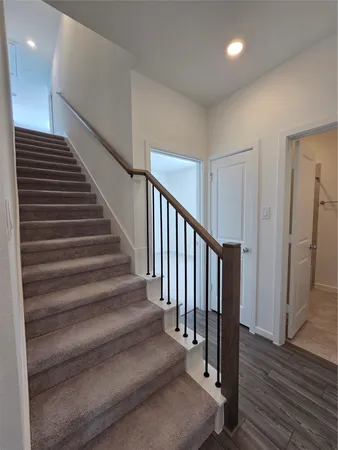 a view of entryway and hall with wooden floor