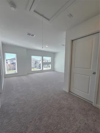 an empty room with windows and closet
