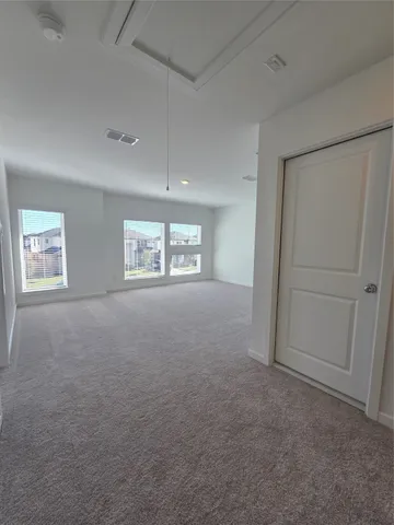 an empty room with windows and closet