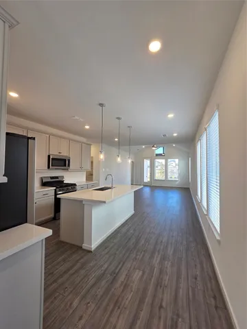 a view of kitchen with sink and wooden floor