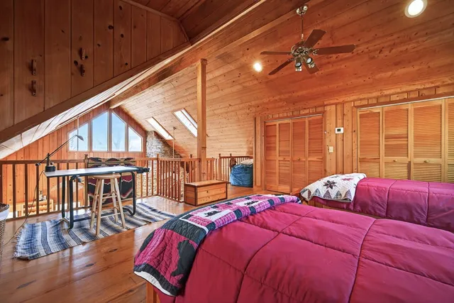 a bedroom with a bed a flat screen tv and balcony view