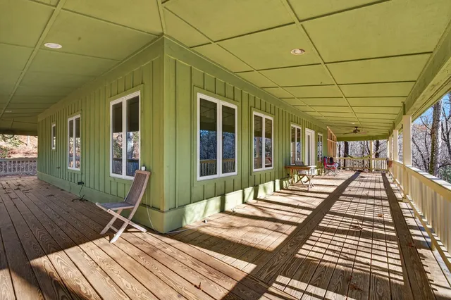 a view of a backyard with wooden floor and iron stairs