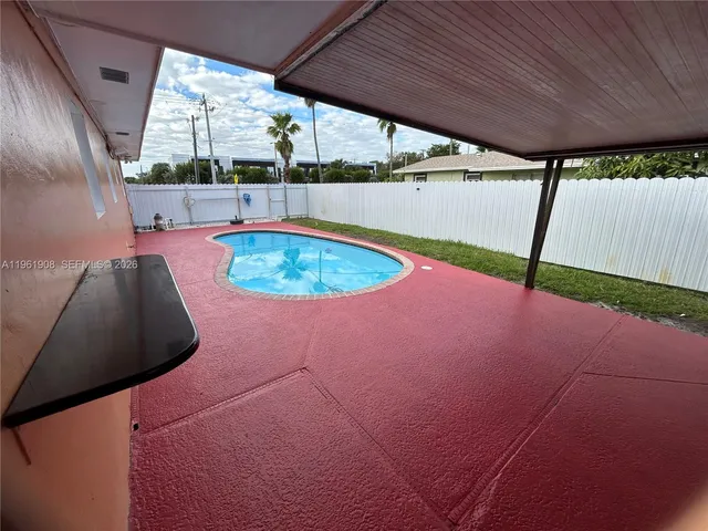 a view of a swimming pool with a yard