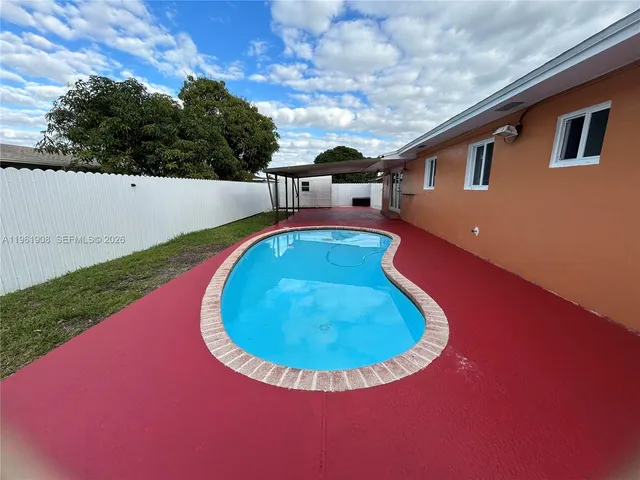 a view of a swimming pool with an outdoor seating