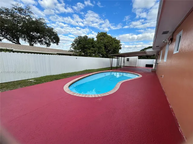 a backyard of a house with table and chairs