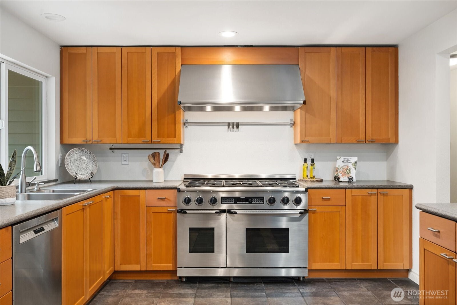 20702 11th Drive Southeast Bothell, WA 98012 - Photo 12 of 38 a kitchen with granite countertop wooden cabinets and stainless steel appliances