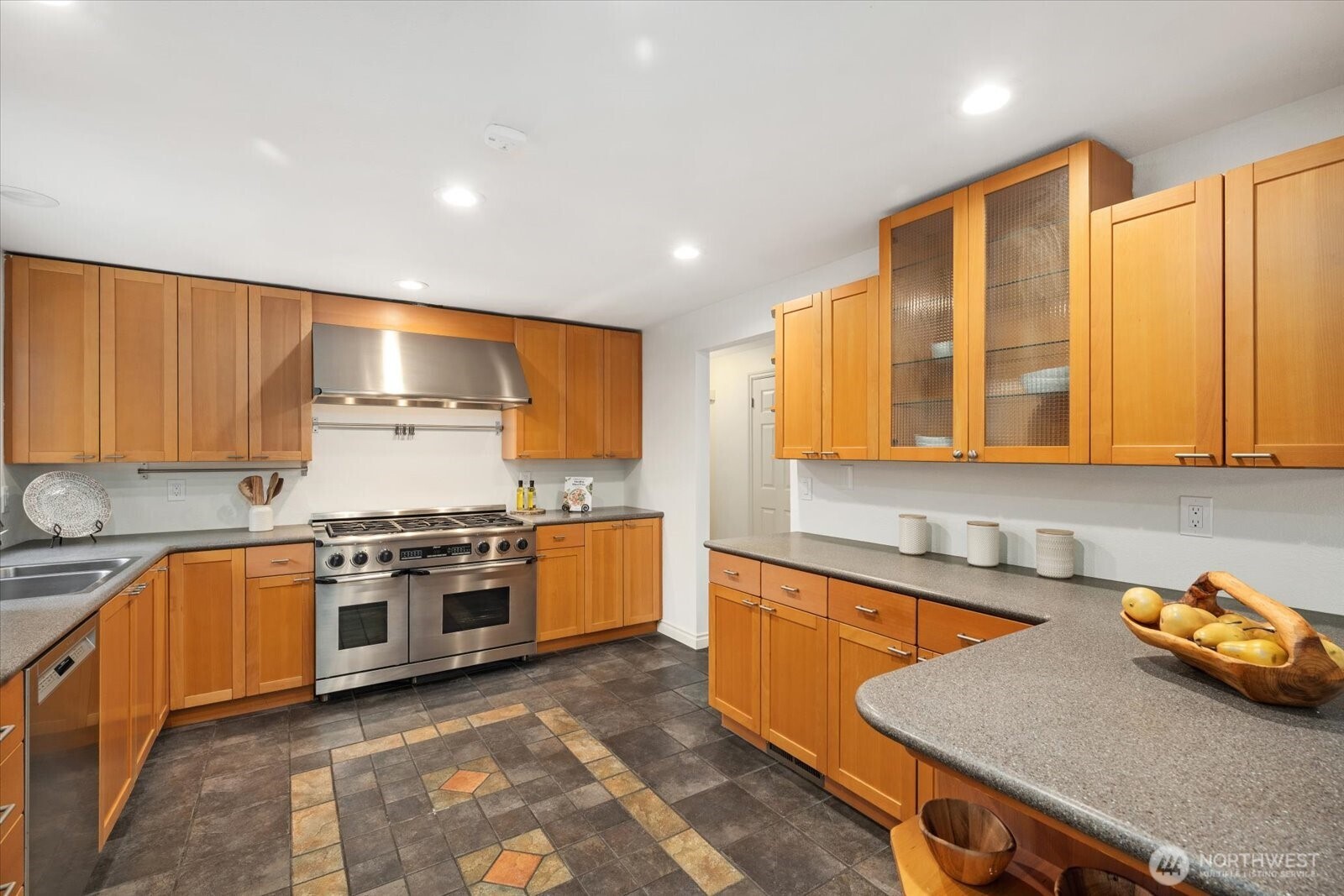 20702 11th Drive Southeast Bothell, WA 98012 - Photo 13 of 38 a kitchen with stainless steel appliances granite countertop a sink stove and cabinets