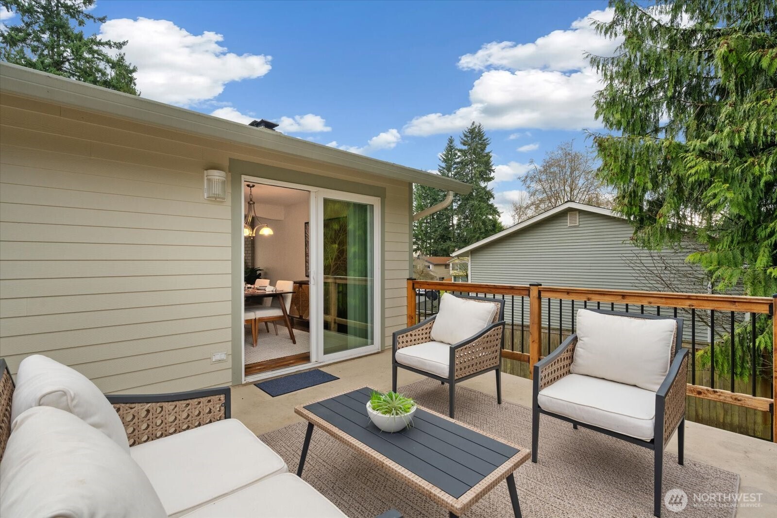 20702 11th Drive Southeast Bothell, WA 98012 - Photo 33 of 38 a view of a patio with couches table and chairs and potted plants