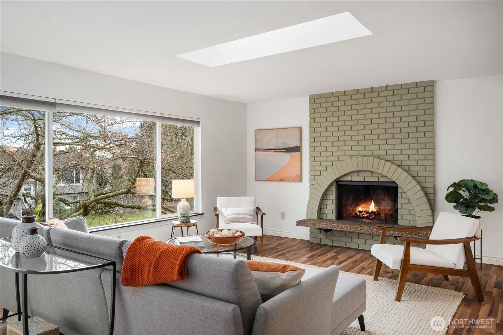 20702 11th Drive Southeast Bothell, WA 98012 - Photo 5 of 38 a living room with furniture a fireplace and a floor to ceiling window